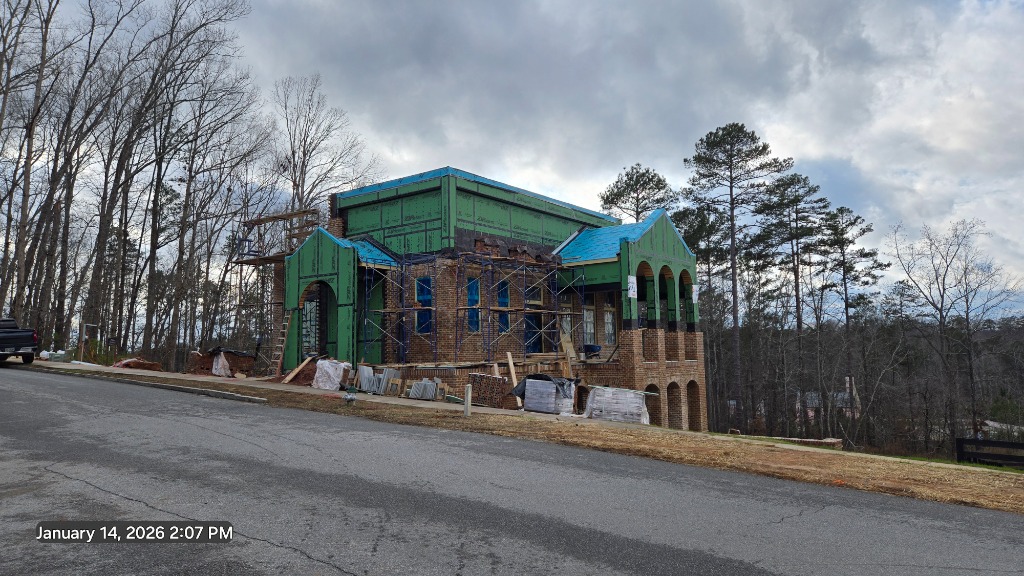 Serenbe McKinney House - Exterior under construction showing brick arches and modern structure