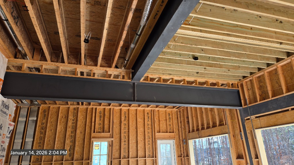 Serenbe McKinney House - Interior construction showing steel beams and wood framing structure